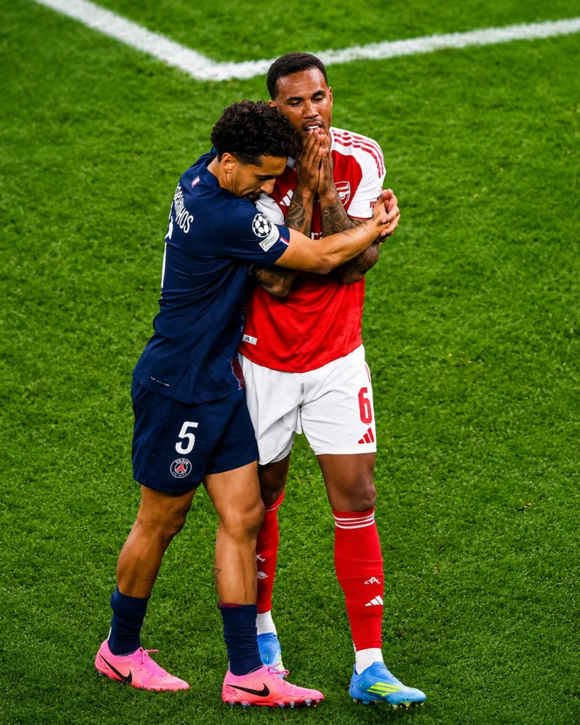 PSG captain Marquinhos consoles Arsenal's Gabriel after the final whistle before joining his teammates' celebrations.
