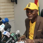 Sports Minister Kofi Adams addressing journalists during a briefing on World Cup travel arrangements
