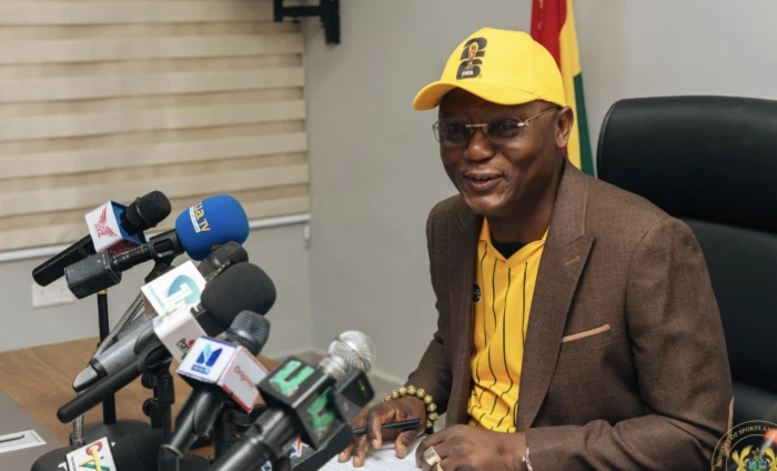 Sports Minister Kofi Adams addressing journalists during a briefing on World Cup travel arrangements