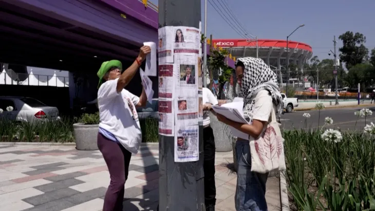Activists place missing-person posters near a Mexico City stadium ahead of the 2026 FIFA World Cup.