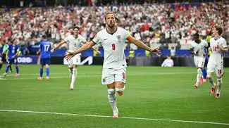 Harry Kane celebrates with England teammates after scoring during England's 4-2 victory over Croatia.
