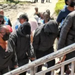 Students under police escort in Kenya after deadly Utumishi Girls Academy fire investigation.
