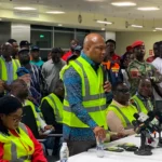 Ghana Foreign Affairs Minister Samuel Okudzeto Ablakwa greets Ghanaian evacuees arriving at Kotoka International Airport from South Africa.
