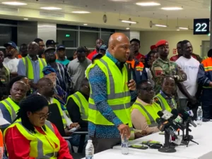 Ghana Foreign Affairs Minister Samuel Okudzeto Ablakwa greets Ghanaian evacuees arriving at Kotoka International Airport from South Africa.