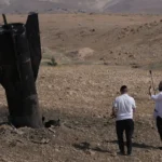 Missile debris embedded in the ground following recent military exchanges between Iran and Israel.