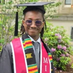 Prince Debrah Jr wearing MIT graduation attire after completing a Computer Science degree.