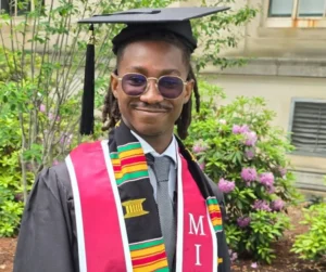 Prince Debrah Jr wearing MIT graduation attire after completing a Computer Science degree.