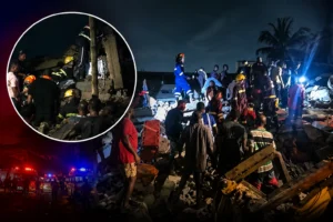 Emergency responders working at the scene of a building collapse in Adenta.