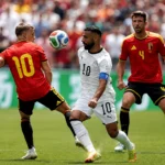 Egypt and Belgium players battle for possession during a World Cup match that ended in a draw.