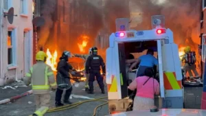 Glider bus on fire during disorder in Belfast following a knife attack.