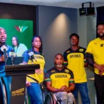Officials and Ghanaian para-athletes pose during a media event ahead of an international sporting competition.