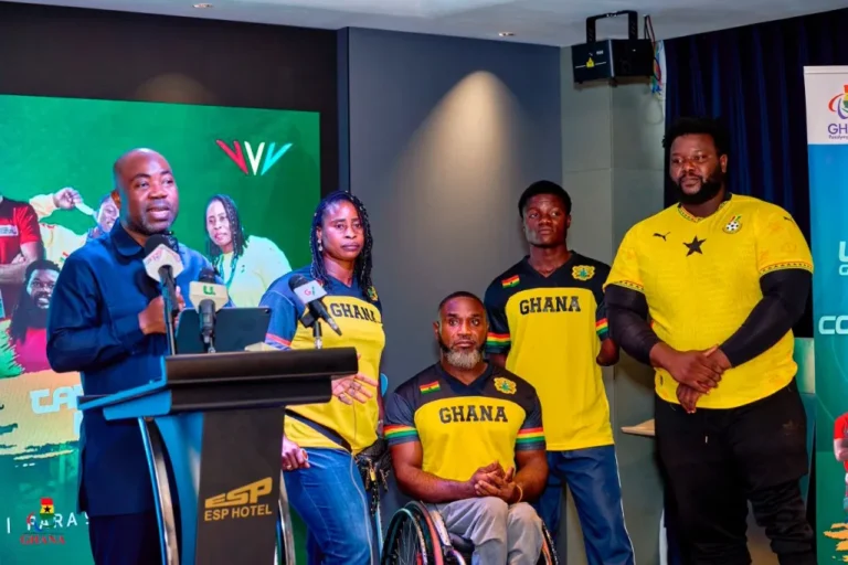 Officials and Ghanaian para-athletes pose during a media event ahead of an international sporting competition.