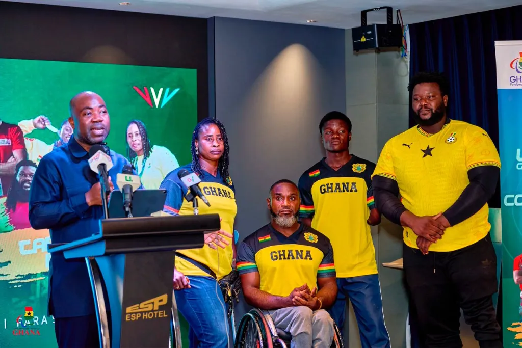 Officials and Ghanaian para-athletes pose during a media event ahead of an international sporting competition.
