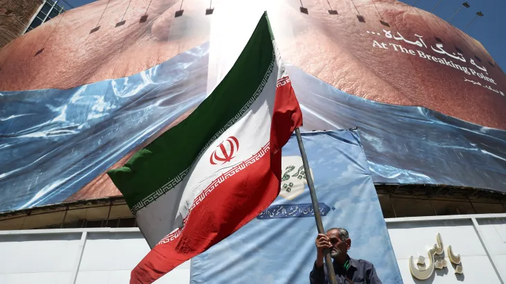 Man waving Iranian Flag