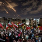 Israel Launches Strikes: Crowds waving Iranian flags gather at night as missile trails streak across the sky above a city amid escalating regional tensions.