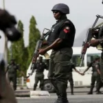 Nigerian police officers on patrol following security warnings over potential reprisals against South African interests.