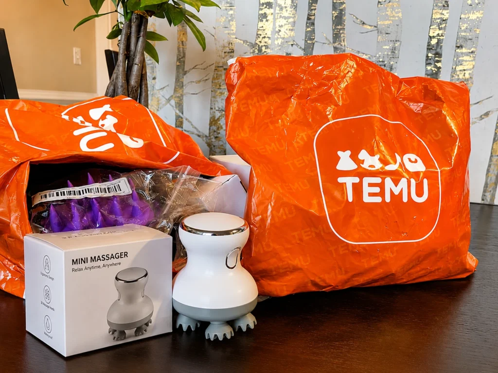 Temu delivery packages displayed alongside a newly unpacked consumer product on a table.