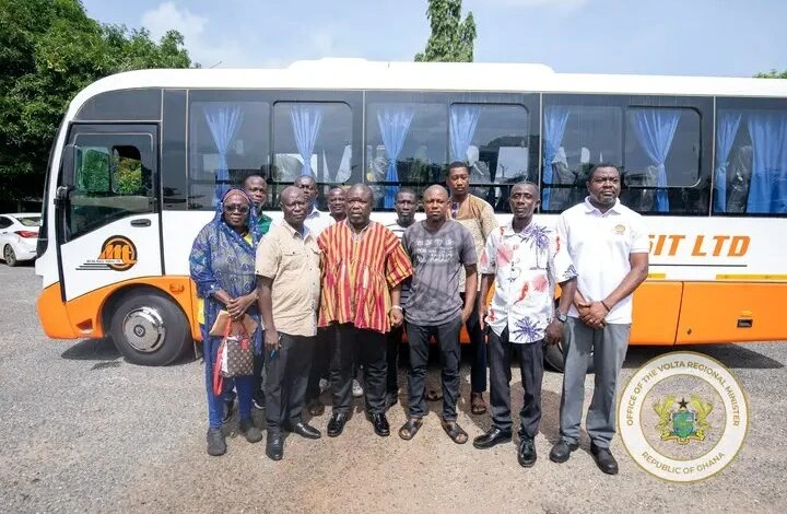 Regional officials and stakeholders pose in front of a newly introduced Metro Mass Transit bus in Ghana's Volta Region.
