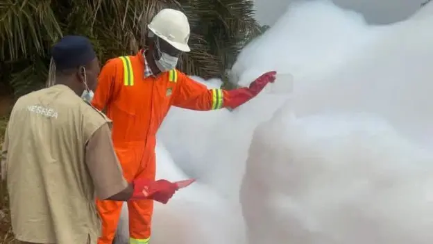 NESREA officials inspecting mysterious white foam beside the Kaduna-Abuja Expressway in Nigeria.