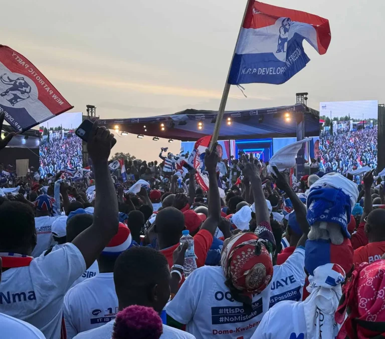Supporters waving New Patriotic Party flags during a political gathering in Ghana.