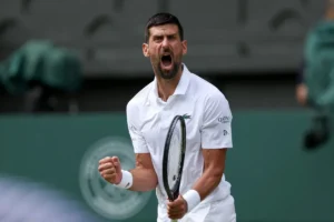 Novak Djokovic celebrates victory after defeating Felix Auger-Aliassime in the Wimbledon quarter-finals.