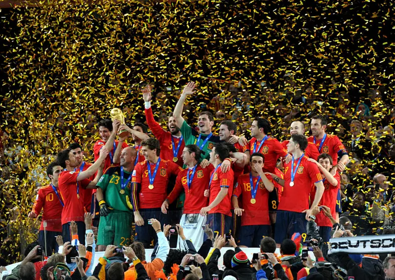 Spain celebrate with the FIFA World Cup trophy following victory over Argentina.