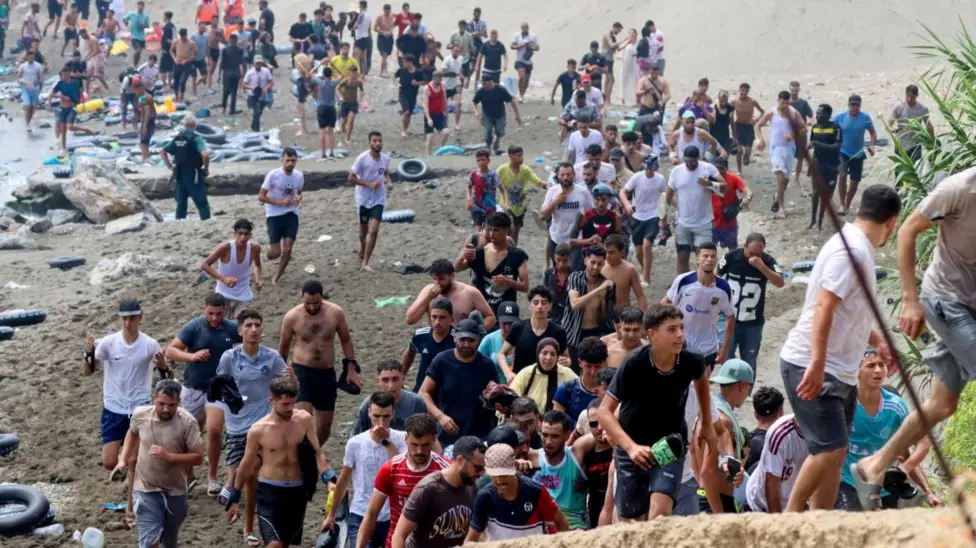 Spanish military vehicles and security personnel deployed across Ceuta following one of the largest migrant crossings ever recorded into the Spanish enclave.