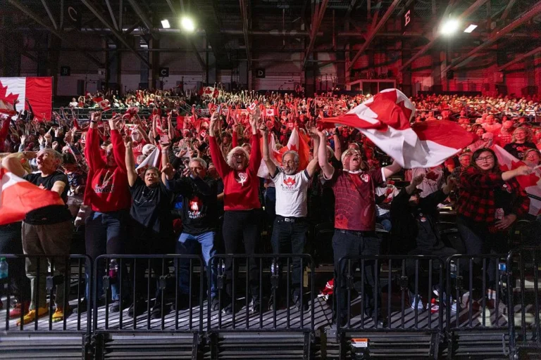 Supporters waving Canadian flags following Alberta's October 2026 referendum, if verified by the photograph.